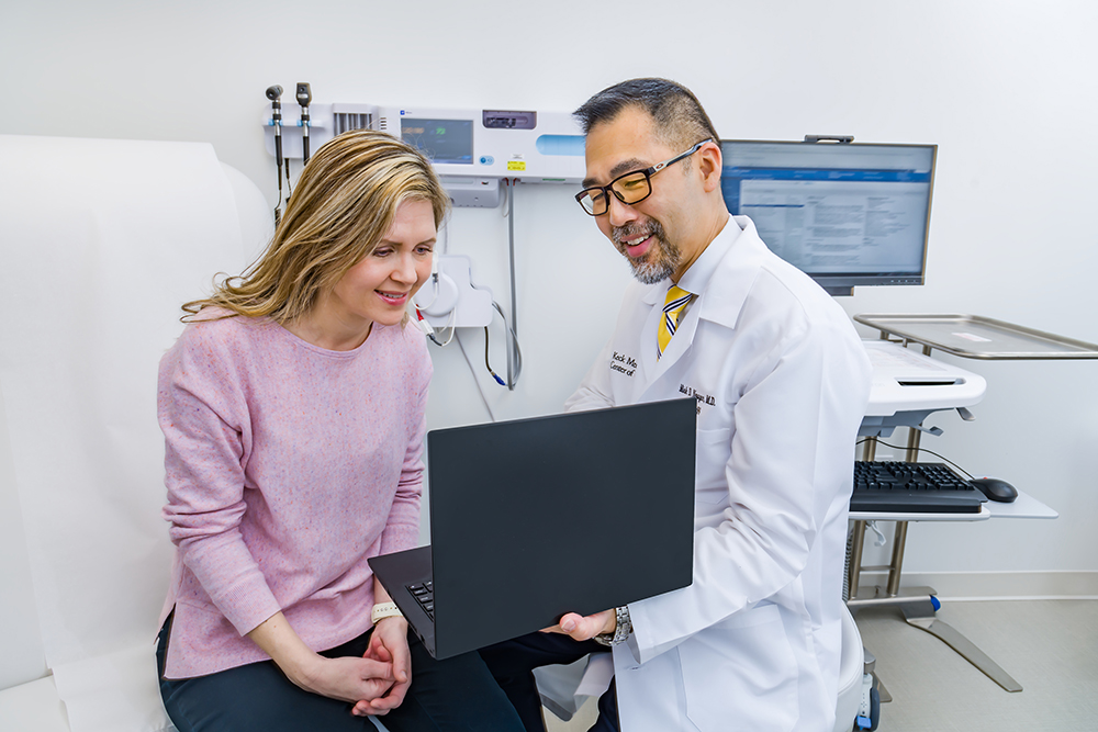 Patient and doctor discuss second opinion in medical office.