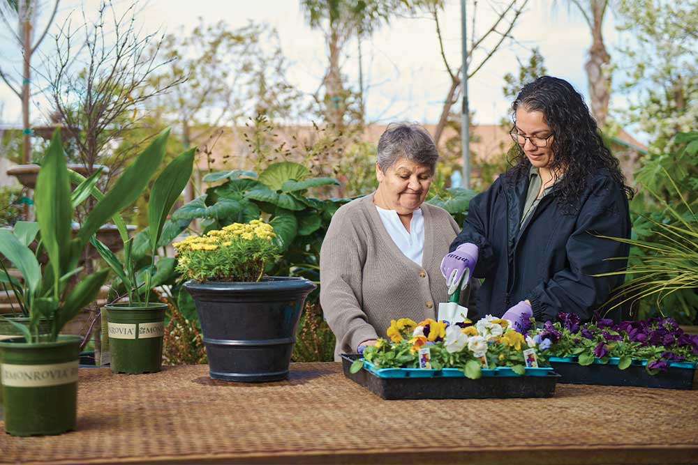 Woman and younger woman looking at flowers