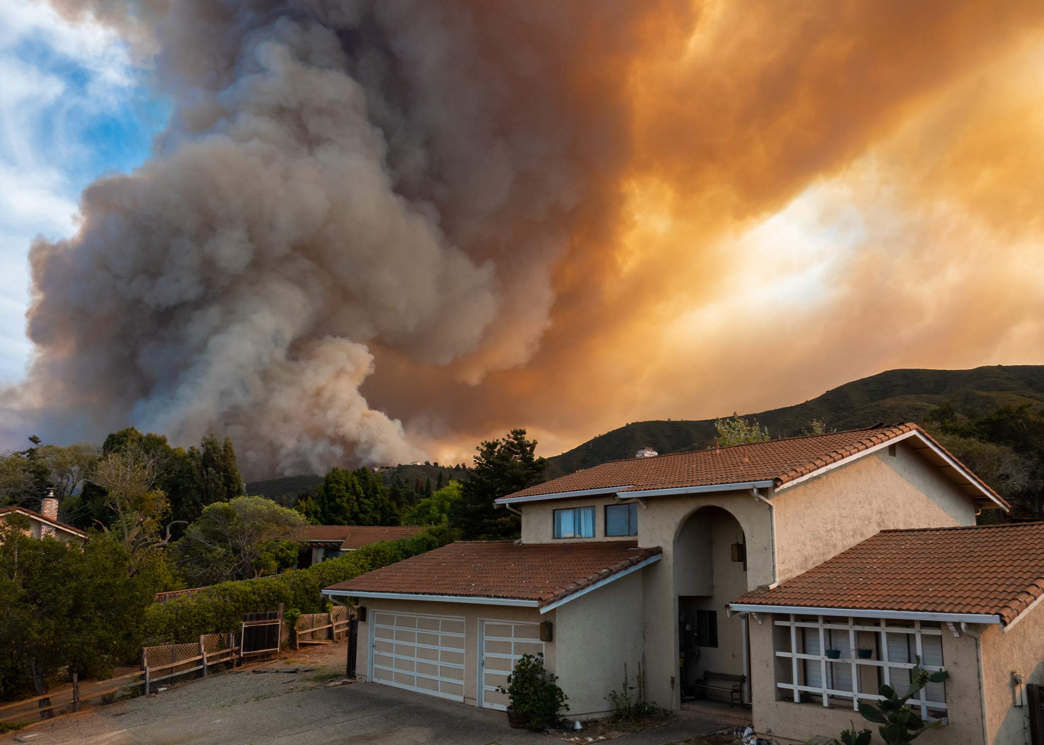 a house with flames behind it.